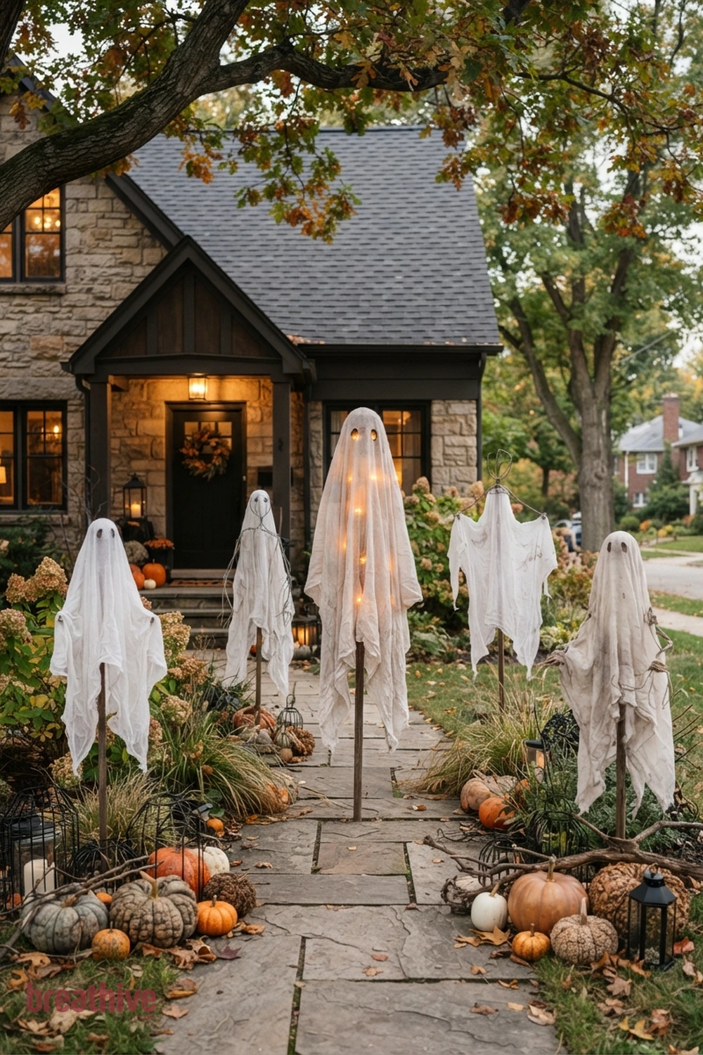 ghost-themed Halloween front yard idea with main outdoor decorative scene positioned where it can be seen clearly without blocking circulation