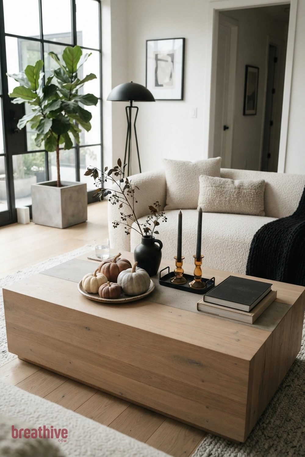 modern minimalist Halloween living room idea with coffee table vignette that leaves usable surface space around seasonal decor