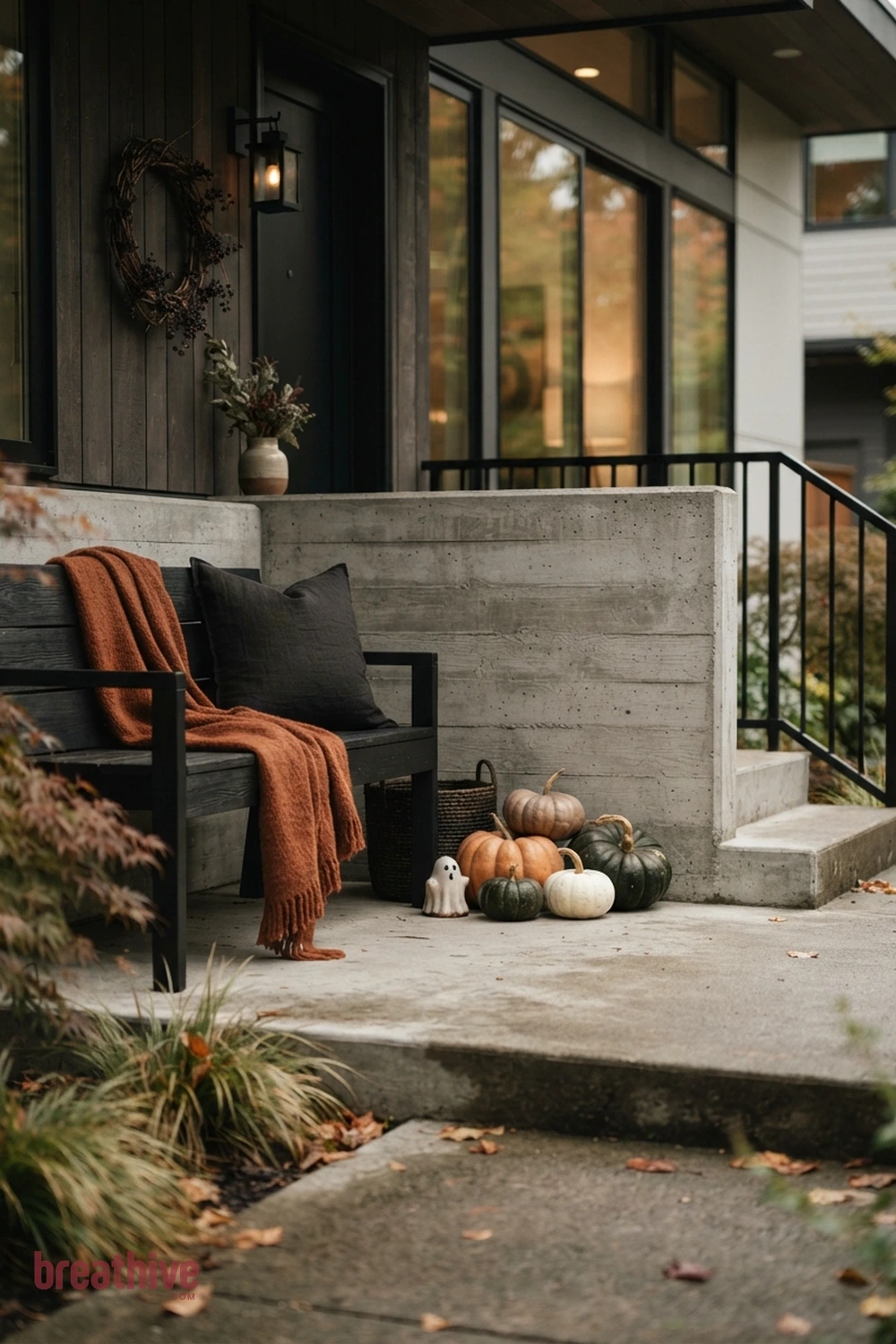 modern Halloween front porch idea with usable bench or chair corner with seasonal layers that do not crowd sitting space