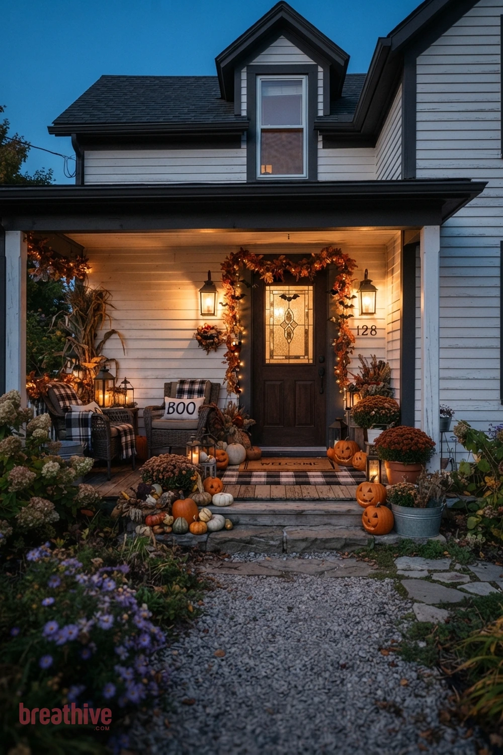 farmhouse Halloween front porch idea with same entry transformed after dusk through layered practical lighting