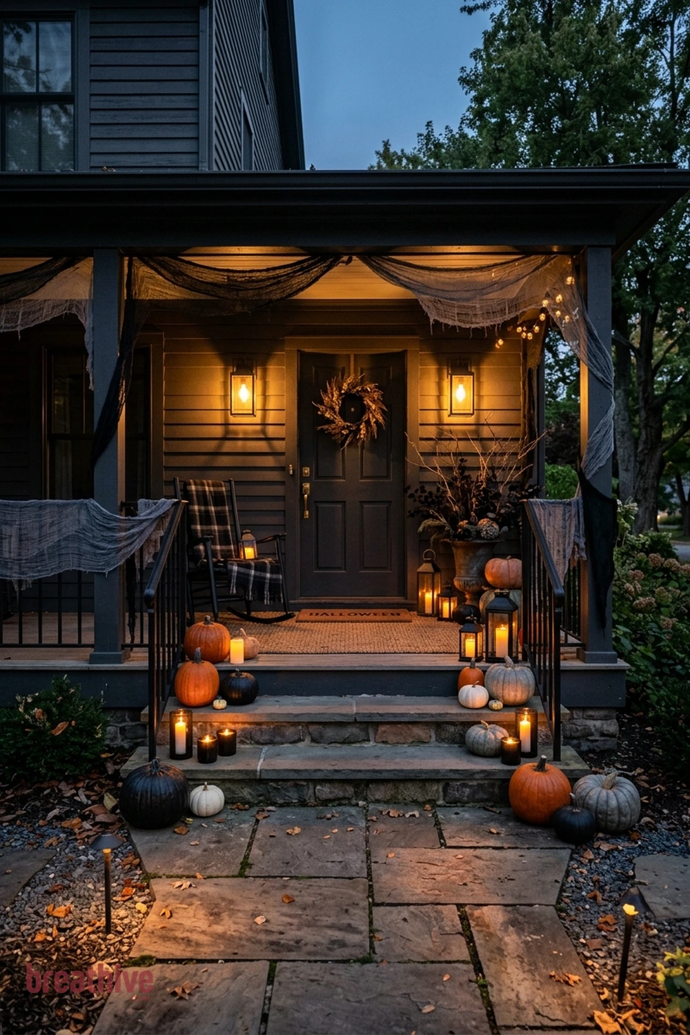 spooky polished Halloween front porch idea with same entry transformed after dusk through layered practical lighting