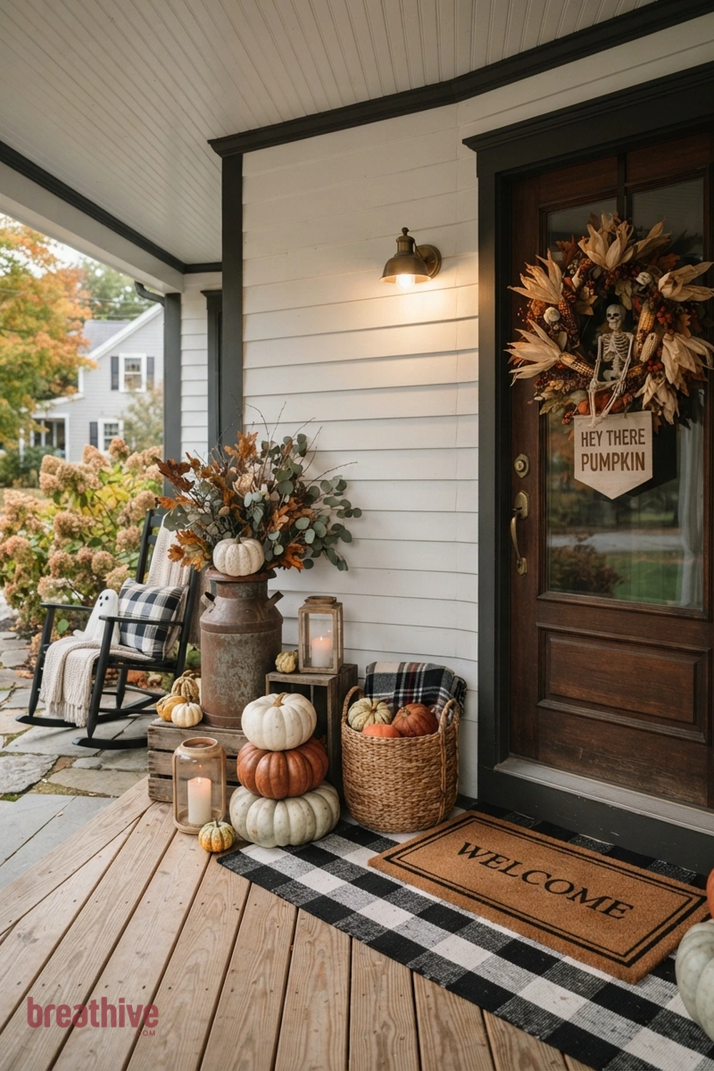 farmhouse Halloween front porch idea with one side of the doorway styled with grouped objects in varied height and scale