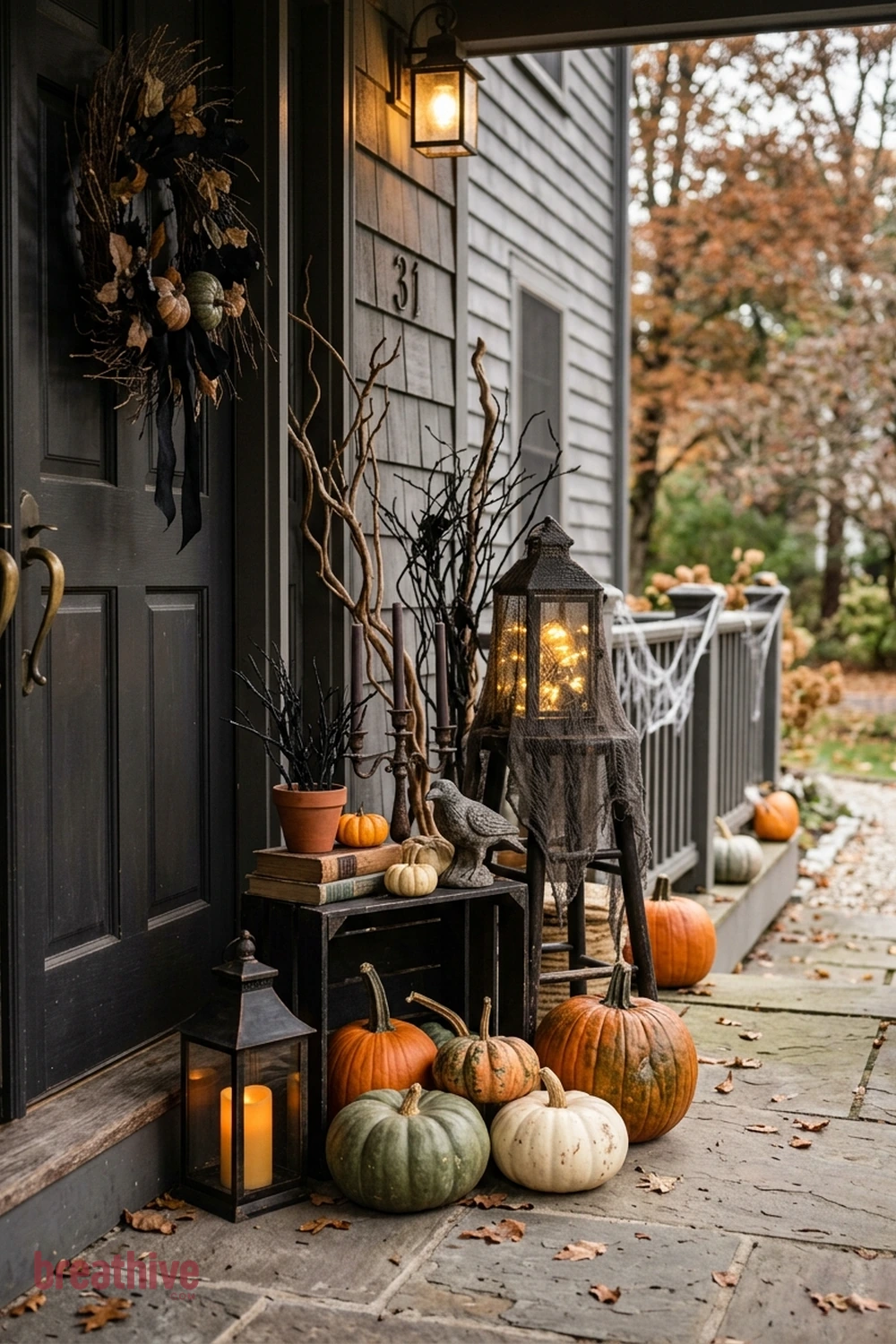 spooky polished Halloween front porch idea with one side of the doorway styled with grouped objects in varied height and scale